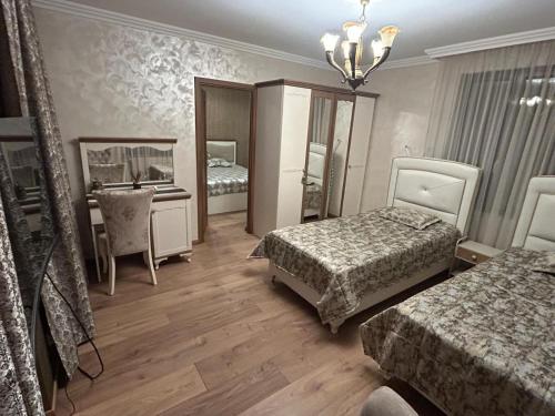 a hotel room with two beds and a mirror at Appartement in Oberschaeffolsheim