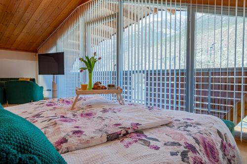 a bedroom with a bed with a table on it at Penthouse Jasmin in Laces