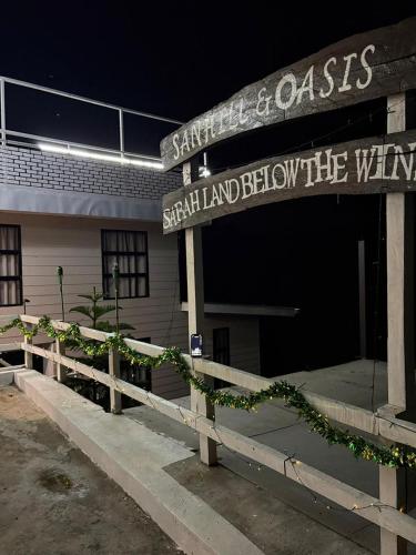 a building with a sign that reads santa cruz island between the wings at Sanhill & Oasis in Ranau