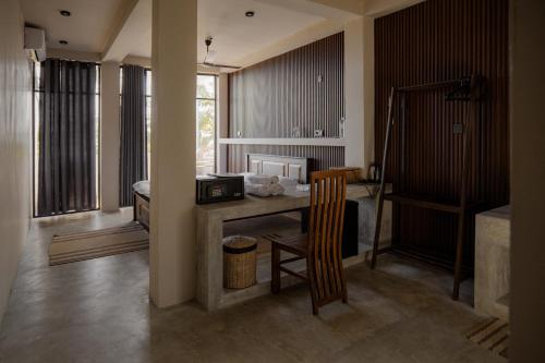 a room with a table and a chair in a room at Surf's Up LOFT in Weligama