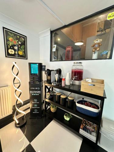a room with a counter with a coffee maker on it at Amsterdam Hotel in London