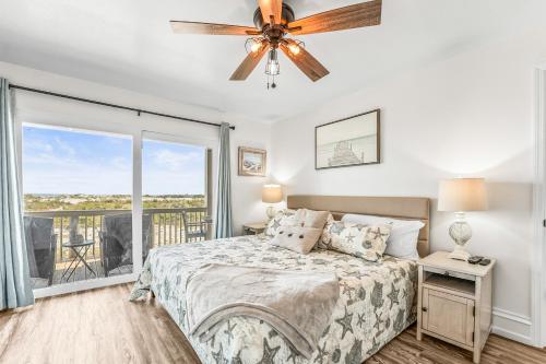 a bedroom with a bed and a ceiling fan at Oceanfront St Helena Island Condo w/ Beach Access! in Oceanmarsh Subdivision