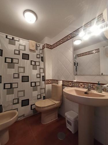 a bathroom with a toilet and a sink at ALCAUDÓN By SIT ISLA CANELA -REF 282- in Ayamonte