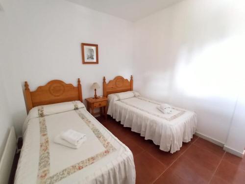 two beds in a room with white walls at ALCAUDÓN By SIT ISLA CANELA -REF 282- in Ayamonte