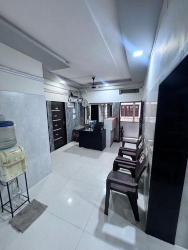 a bathroom with a row of chairs in a room at Radha Krishna Guest House in Surat
