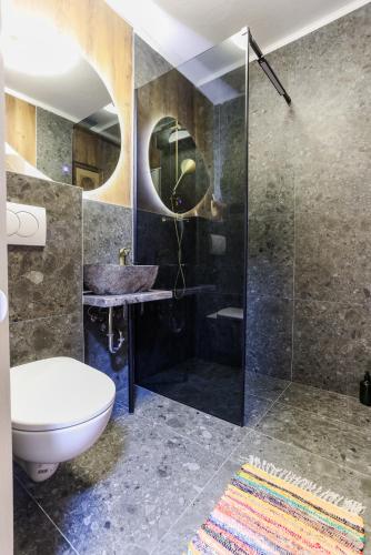a bathroom with a toilet and a sink and a shower at Boutique Suite 02 Chic in Zadar