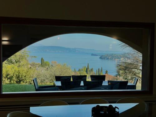 a large window with a view of a lake at Villa Allegra Luxury Holiday House in Salò