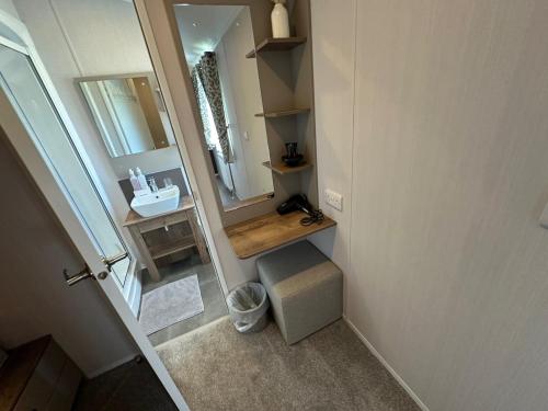 a small bathroom with a sink and a mirror at Luxury Lakeside Lodge L2 with Hot tub situated at Tattershall Lakes Country Park in Tattershall
