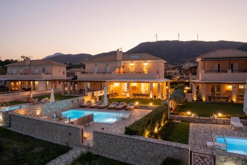 a villa with a swimming pool at night at Seafront Villa Ciel with Private Pool in Nafpaktos in Nafpaktos