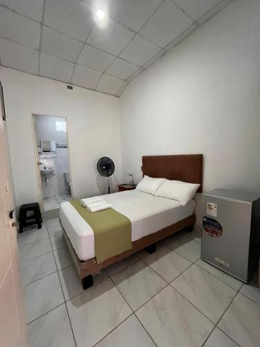 a bedroom with a large bed and a bathroom at HospedajesPerú in Zorritos