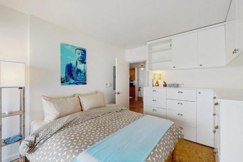 a white bedroom with a bed and a dresser at Pike Place Pearl in Seattle