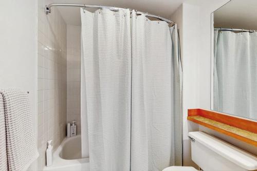 a bathroom with a shower curtain and a bath tub at Pike Place Pearl in Seattle