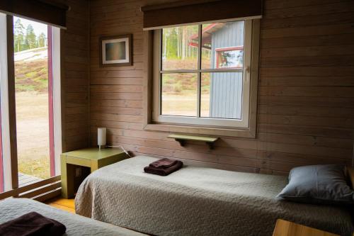 a bedroom with two beds and a window at Kempings Ozolkalns in Cēsis