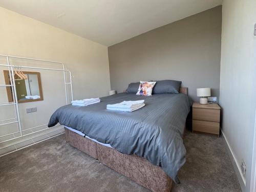 a bedroom with a large bed in a room at 2 Bedroom Bungalow by the Arches in Earlestown