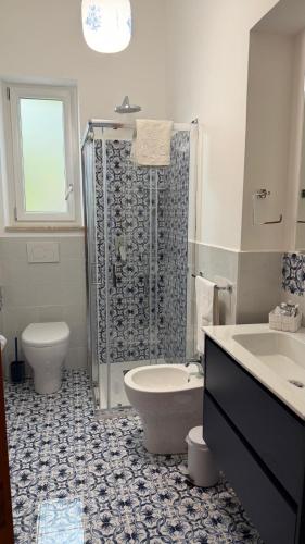a bathroom with a shower and a toilet and a sink at La casa del Capitano, l'uomo e il mare ... in Lipari