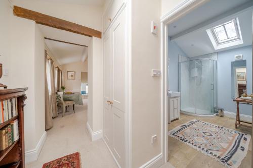 a bathroom with a shower and a walk in closet at Blackmoor View Cottage in Sherborne
