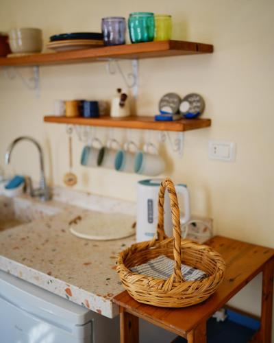 a basket sitting on a counter in a kitchen at The Happinesst بيت فرح in Anfah