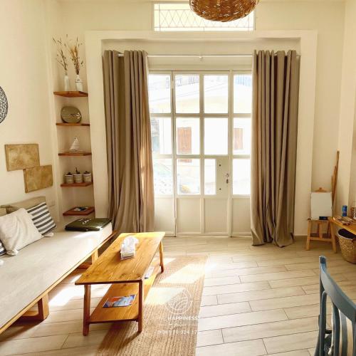 a living room with a couch and a large window at The Happinesst بيت فرح in Anfah