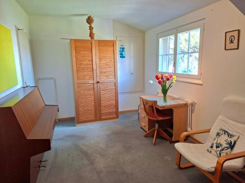 a living room with a vase of flowers on a table at finaly peace in Geneva