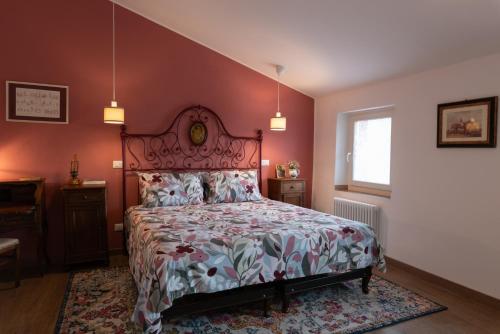 a bedroom with a bed with a floral bedspread at RoncoBèrtolo R&B in Loiano