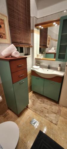 a bathroom with a sink and a mirror at Sea & Mountain View Apartment in Chalkida