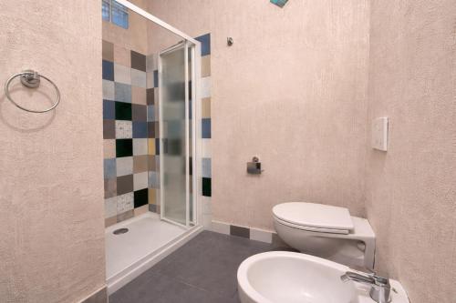 a bathroom with a toilet and a sink and a shower at Sant'Agostino in Pizzo