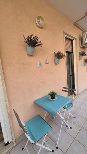 a blue table and two chairs on a patio at Soffio Marino in Polignano a Mare