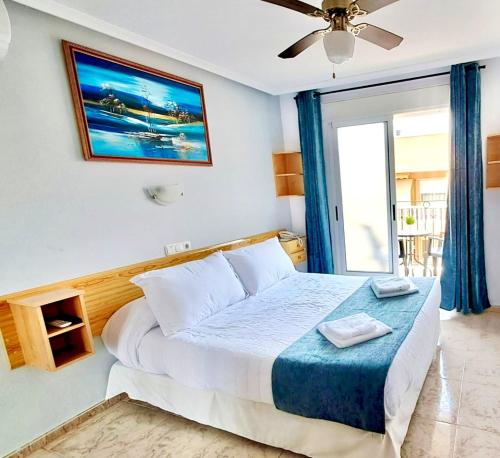 a bedroom with a large bed and a window at Hotel Alaska in San Pedro del Pinatar