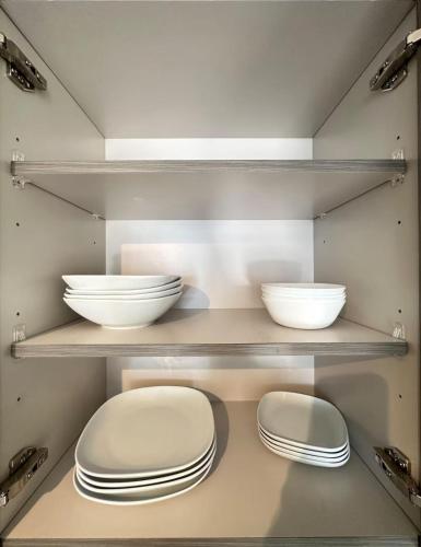 a shelf with bowls and plates on it at Bonito doral in Miami