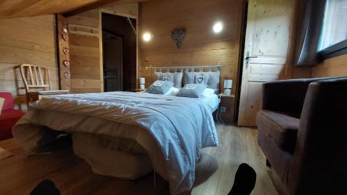 a bedroom with a bed in a room with wooden walls at Snow in Lamoura