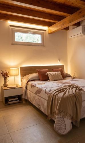 a bedroom with a large bed with a window at Casa Asprigna in Ficarazzi