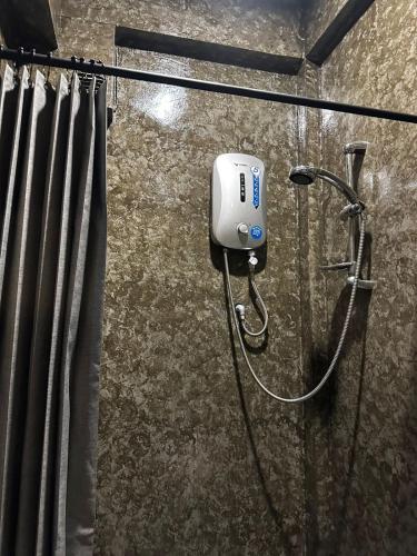 a shower in a bathroom with aitizer at Mojo Hostel in Puerto Princesa City