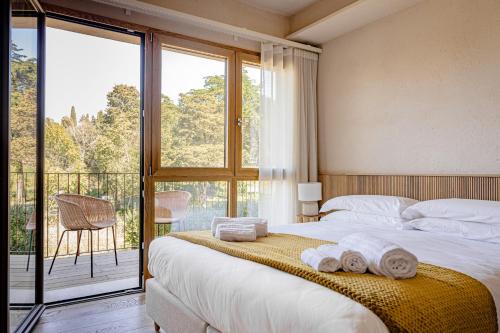 a bedroom with a bed and a large window at Valle Benedetta Retreat Center in Livorno