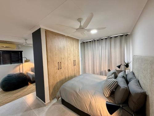 a bedroom with a bed and a ceiling fan at Executive Suite South Fork in Kimberley