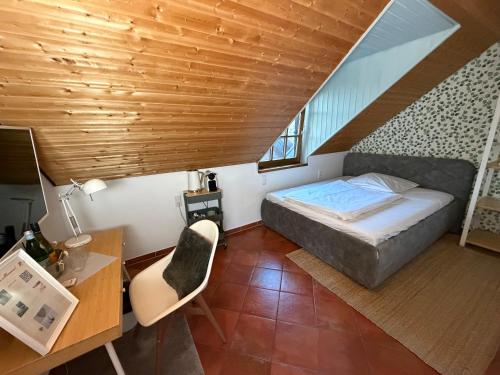 a small room with a bed and a desk and a desk at Oldenburger Mühle in Oldenburg