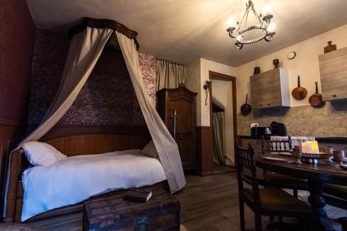 a bedroom with a bed with a mosquito net at Le Logis des Seigneurs in La Flocellière