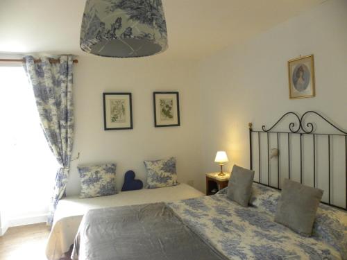 a bedroom with a bed and a window at MAISON des FORGES in Buffon