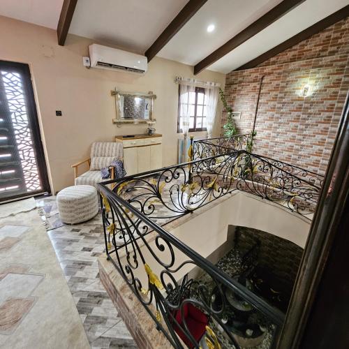 a spiral staircase in a room with a brick wall at Penthouse in Le Hamiz