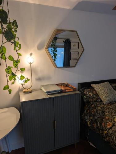 a bedroom with a table with a mirror and a bed at Stylish central Horsham residence with parking and hot tub in Horsham