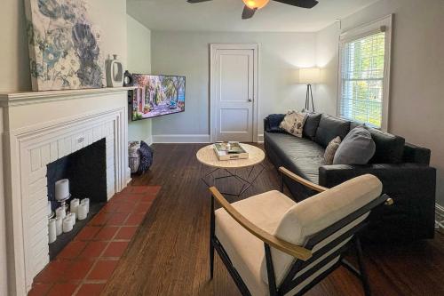 a living room with a couch and a fireplace at 3 Mi to Dtwn Charlotte! Quiet Haven with Fenced Yard in Charlotte