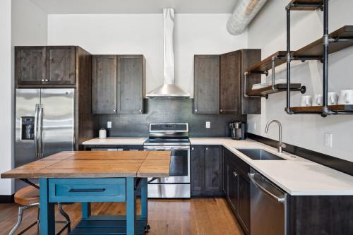 a kitchen with wooden cabinets and a wooden table at Downtown Gem in Whitefish