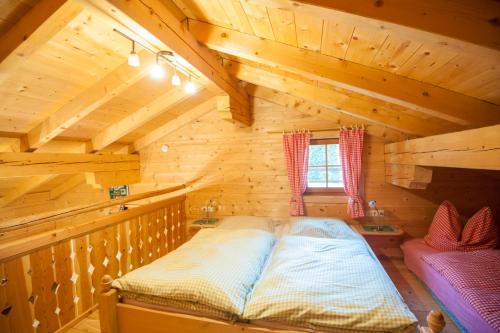 a bedroom with a bed in a log cabin at Schröckhütte in Bad Hofgastein
