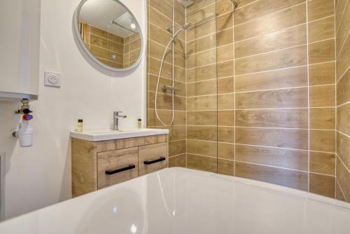 a bathroom with a tub and a sink and a mirror at Studio 2p rénové - Centre 5min- Stationnement in Angoulême