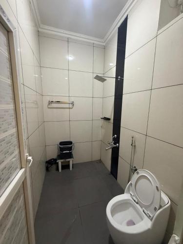 a bathroom with a toilet and a sink at Nirmala Grand in Rāmeswaram