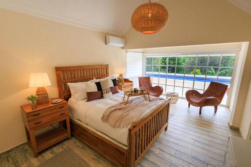 a bedroom with a bed with a table and chairs at Spacious Villa in La Cuaba, Pool in Pedro Brand