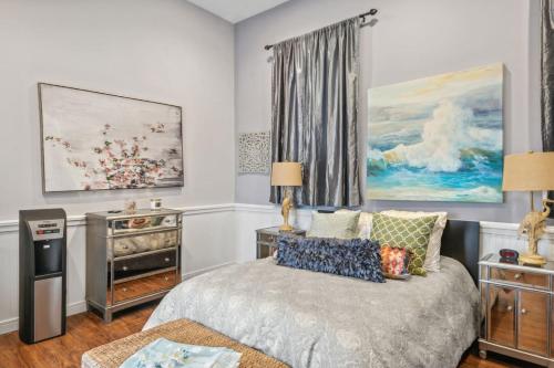 a bedroom with a bed and a painting on the wall at Hamptons Romantic Waterfront Queen Suite in Remsenburg