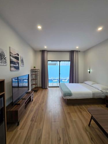 a bedroom with a large bed and a television at MSResort Panglao in Looc