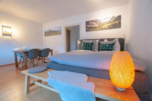 a bedroom with a bed and a table with chairs at Ferienwohnung Steinfeldstrasse am Tegernsee in Rottach-Egern