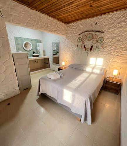 a bedroom with a large white bed in a room at Boutique Playa DanRay in La Perdiz