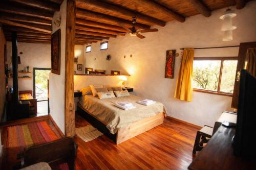 a bedroom with a bed in a room with wooden floors at Casa Atardecer San Javier in San Javier